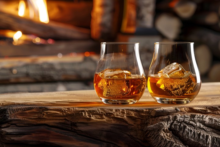 a glass of wine sitting on top of a wooden table